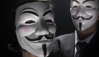 prague march 6: two members of anonymous activist hacker group with mask studio shot